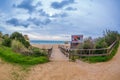 Footpath among beautiful green trees and grass leading to the famous beach in Alvor, Algarve, Portugal. Royalty Free Stock Photo